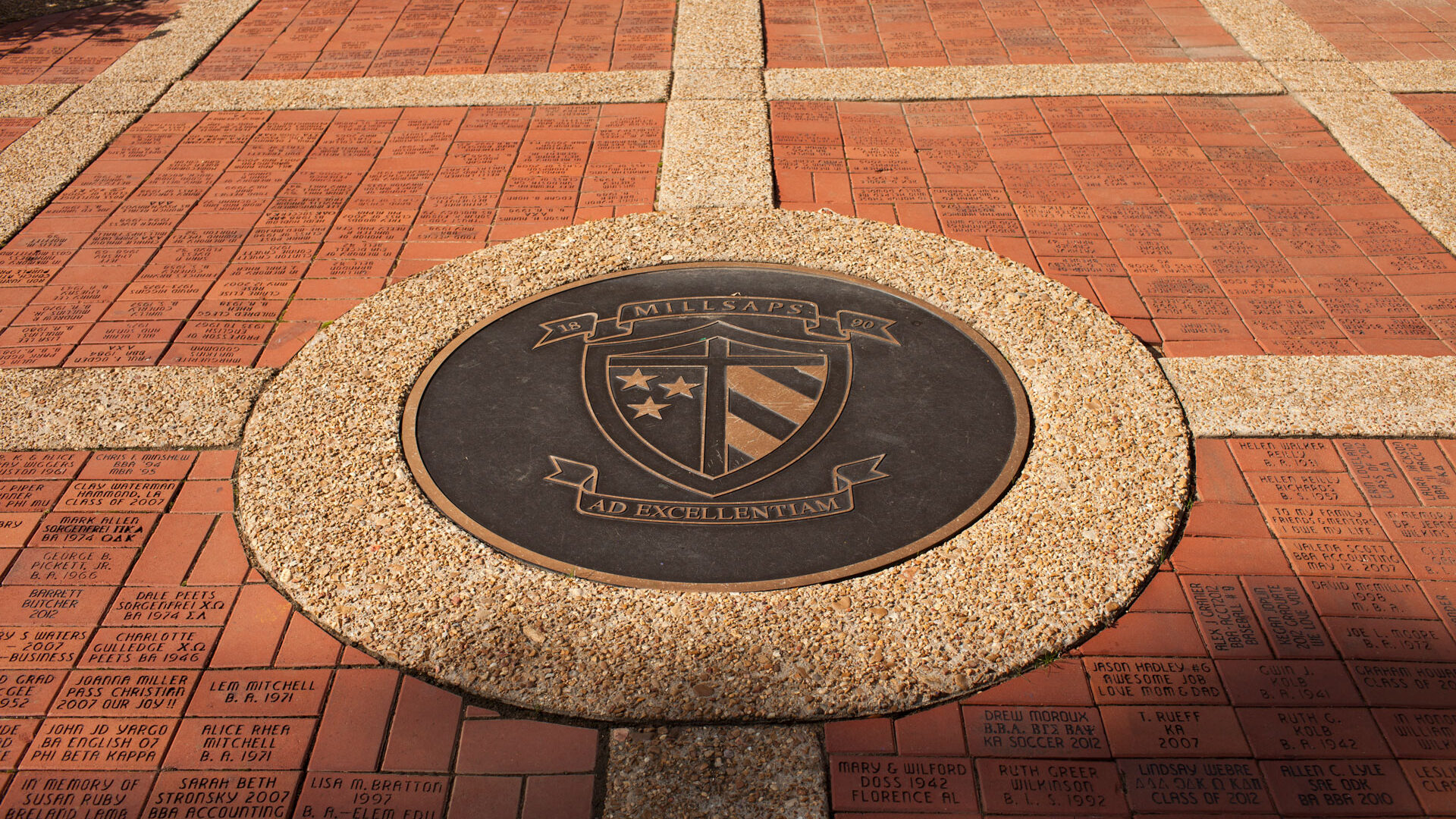 The Millsaps Crest in the bowl - a crest with stripes and stars set into a brick and stone walkway