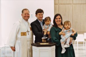 Ricky James (L) stands with Andrew Marion (C) and Kelly Marion as the Marions hold their twins, Paul and Martha.